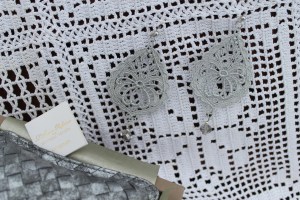 Silver drop shape Venetian lace earrings with swarovski crystal and silver hardware here with Bottega Veneta perfumed silver pouch