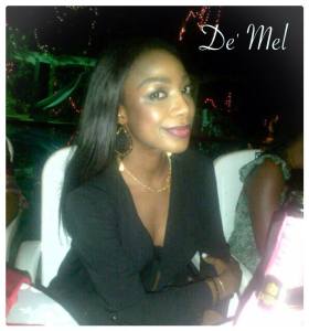 Nigerian beauty wearing De' Mel Venetian lace earrings in black with gold detail and gold hardware